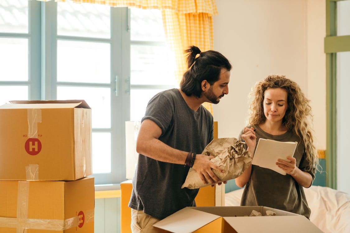 A couple goes through their packing list while preparing for a big move.