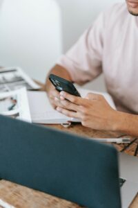 Man using his phone to put up ads.