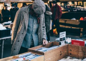 Person checking out garage sale items.