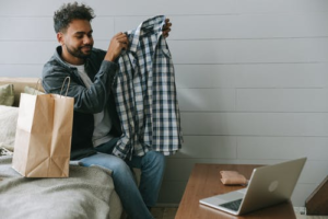 a man holding a clothing item