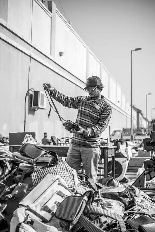 a person buying old items from a yard sale